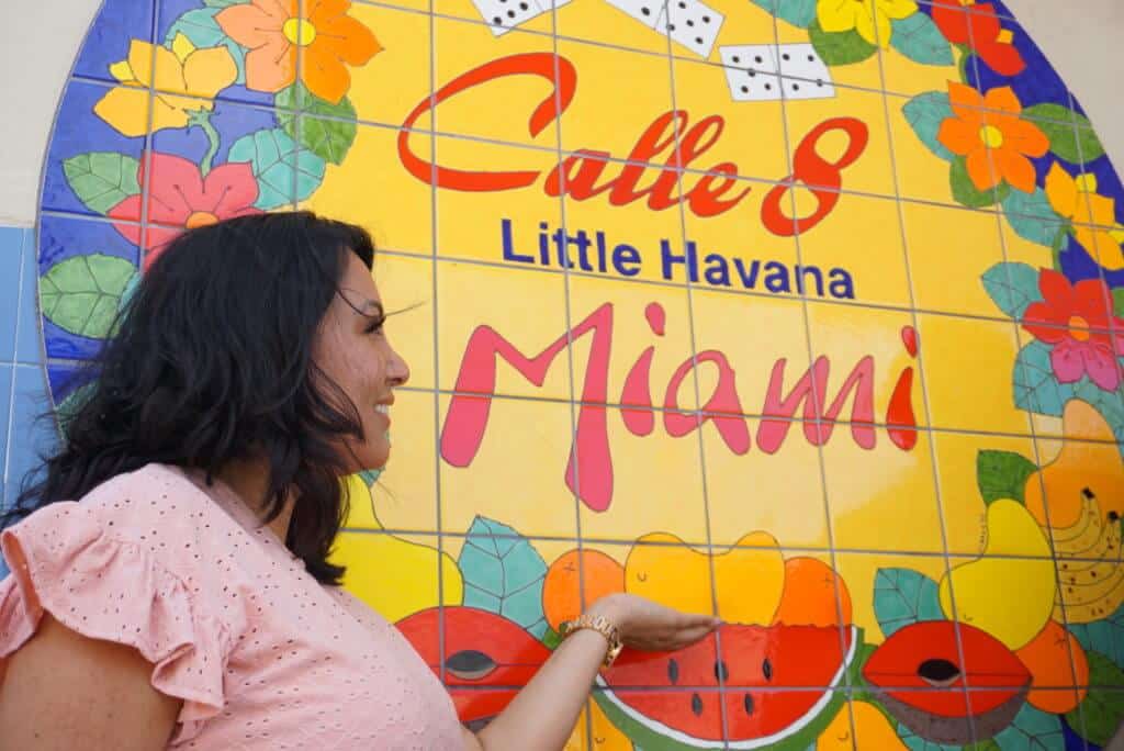 Attorney Nadja A. Prias motioning towards Miami mural
